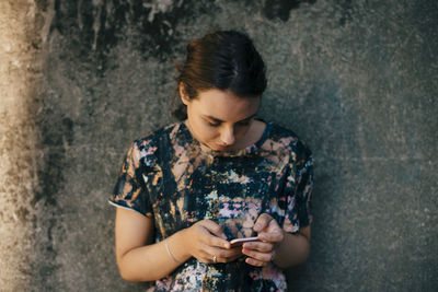 Young woman using mobile phone outdoors