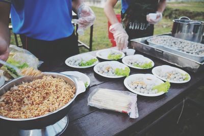 People preparing food on table