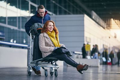 Young couple sitting at airport