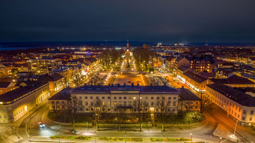 High angle view of illuminated buildings in city at night