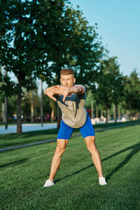 Full length of young man sitting on grass