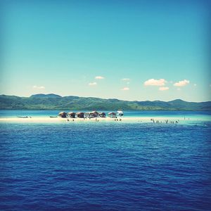 Scenic view of sea against blue sky