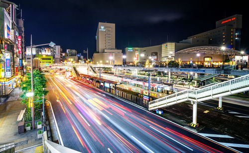 Light trails on road along buildings at night