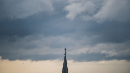 Low angle view of communications tower against sky