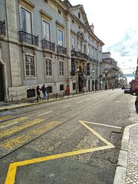 Group of people on road against buildings in city