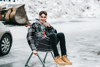 Portrait of young man sitting outdoors