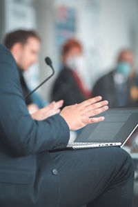 Man with laptop having a presentation at seminar gathering