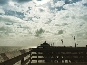 Silhouette pier over sea against sky