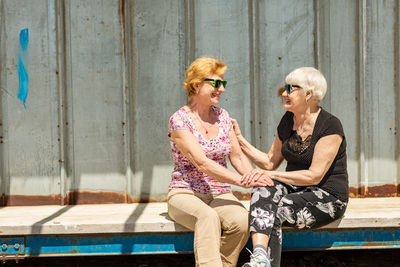 Two elderly women are happy to meet each other