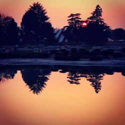 Scenic view of lake against orange sky