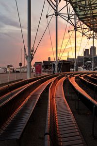 Railroad tracks against sky during sunset