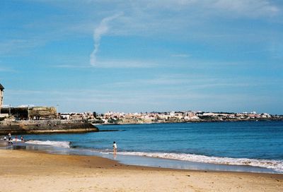 Scenic view of beach against blue sky