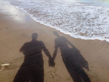 Shadow of people on beach