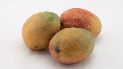 Close-up of oranges against white background