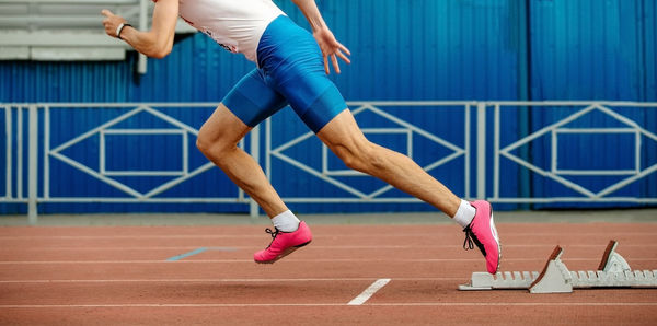 Low section of woman running