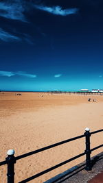 Scenic view of beach against blue sky