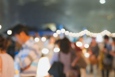 Defocused image of people at night