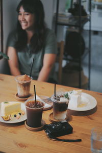 Woman sitting on table at restaurant