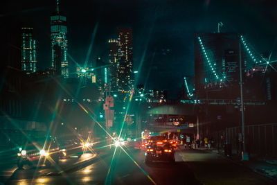 Illuminated cityscape against sky at night