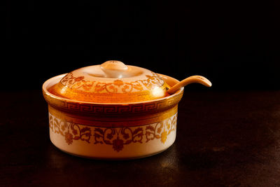 Close-up of coffee cup against black background