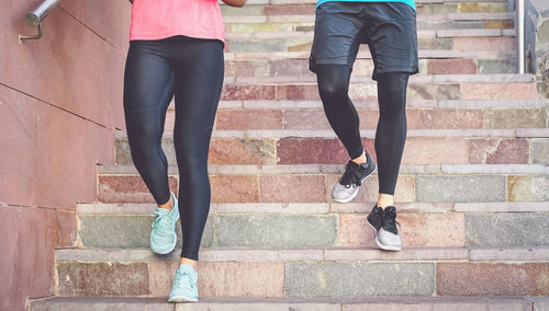 Low section of people walking on staircase