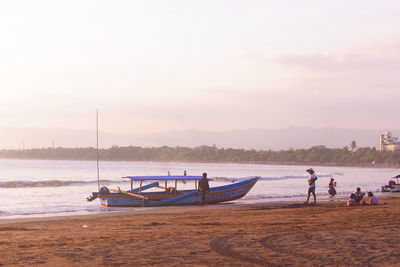 People on beach against sky