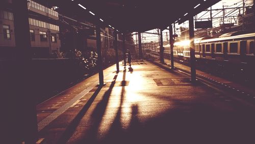 Man walking on illuminated road in city