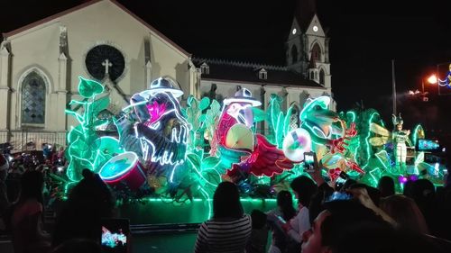 Group of people in front of building at night