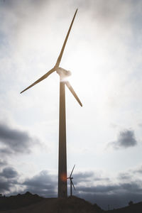 Low angle view of windmill against sky