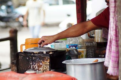 Man preparing food at market stall