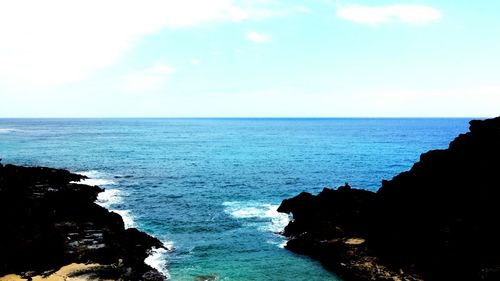 Scenic view of sea against blue sky