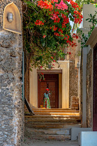 A woman standing at the front of an old lamu door