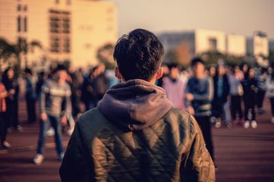 Midsection of man with city in background