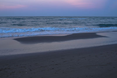 Scenic view of beach against sky during sunset