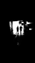 Silhouette people walking in subway