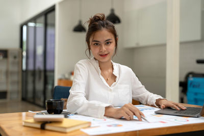 Young businesswoman working at office