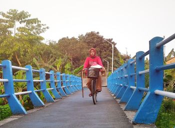 Full length of woman on railing against clear sky