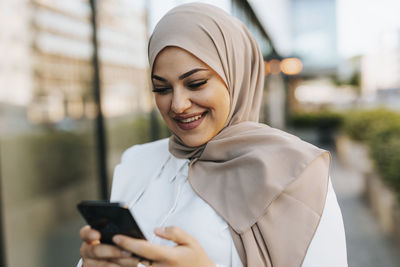 Smiling woman using cell phone