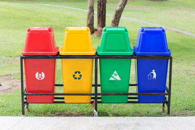 Multi colored garbage bins at park