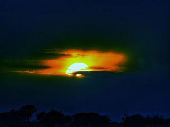 Low angle view of silhouette moon against sky at night