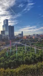 View of cityscape against cloudy sky