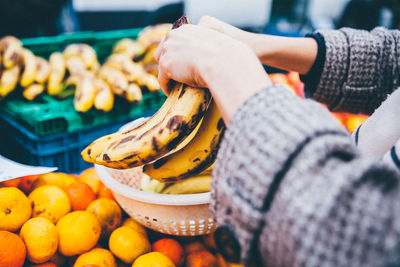 Close-up of hands holding bananas