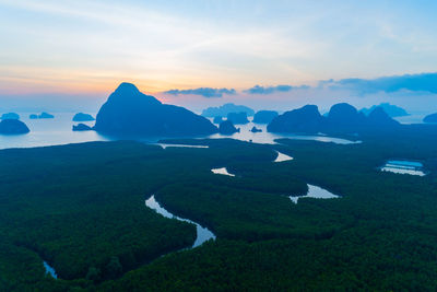 Aerial view drone shot of beautiful sunrise sky in the morning drone flying over sea and forest 