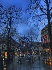 Trees in city against sky