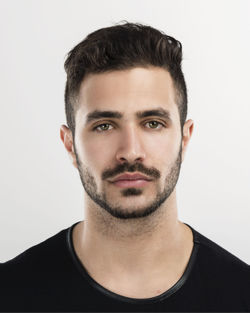 Portrait of young man against white background