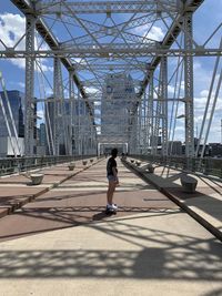 Teenage girl standing on bridge