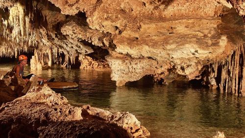 Woman rafting on river in cave at yucatan