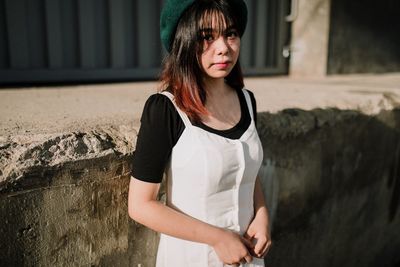 Portrait of beautiful young woman standing outdoors