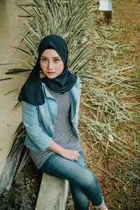 Portrait of young woman sitting outdoors