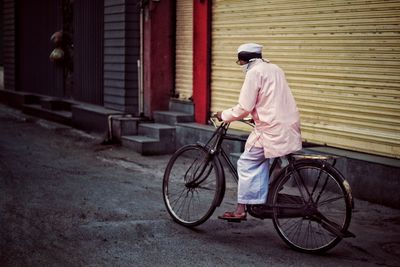 Man riding bicycle on street